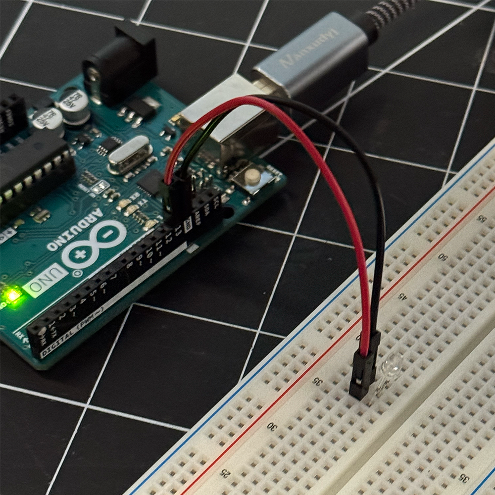 The first activity image shows the Arduino wired up to a breadboard where we used a simple C++ code to make an LED blink on and off. In this image we used two male to male wires to connect the Arduino through its pins to the breadboard.