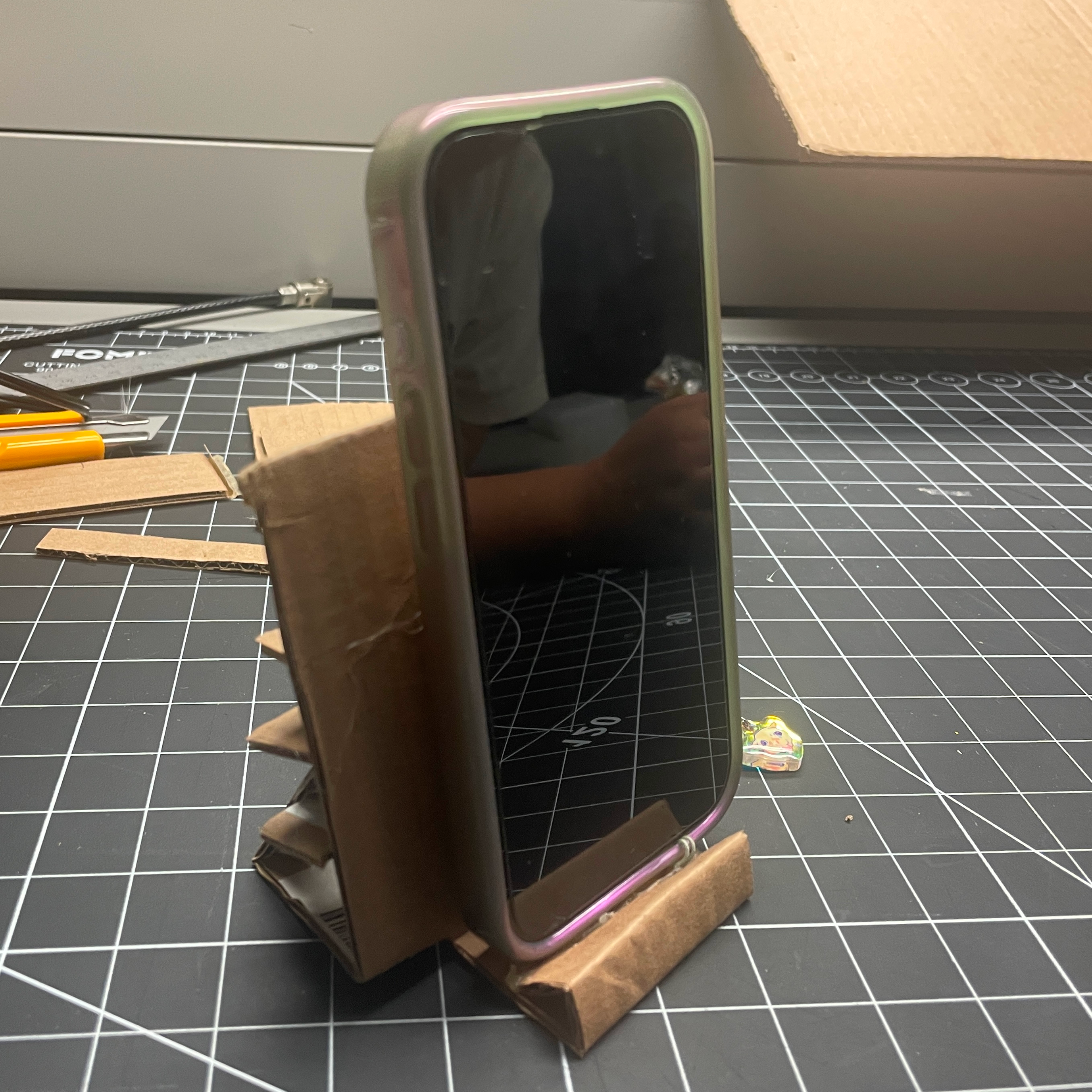 This is an image of the new iteration of the phone stand in action holding my phone.